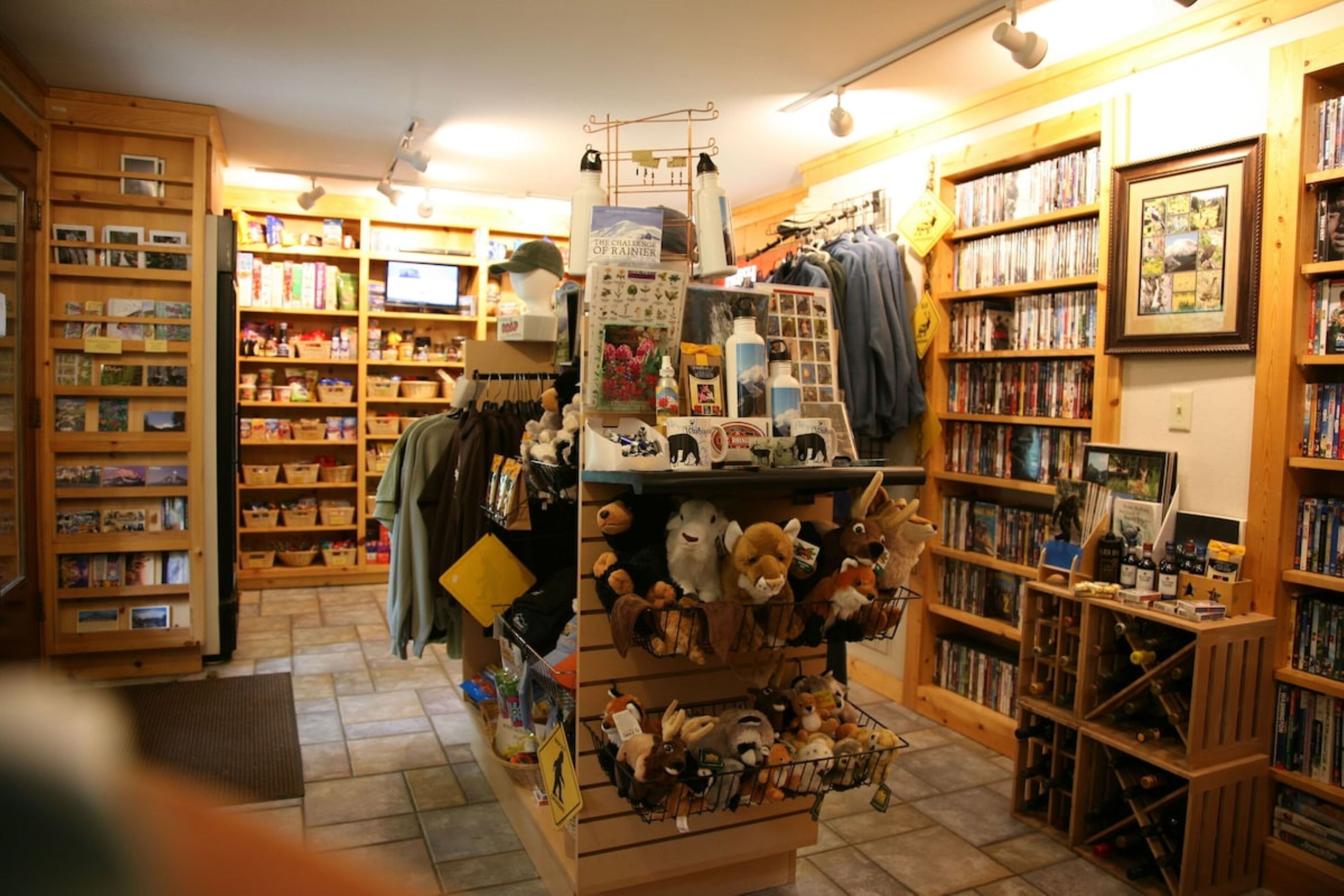 A bookstore with wooden shelves filled with books and various items.
