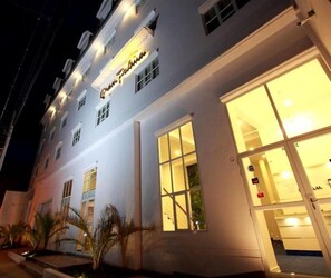Un hotel con un llamativo letrero que dice "Grand Palace".