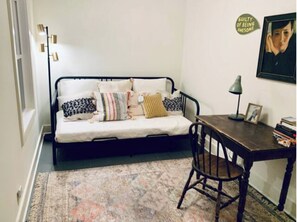 Relax in this compact living space with a sofa, table, and chair, perfect for unwinding or working.