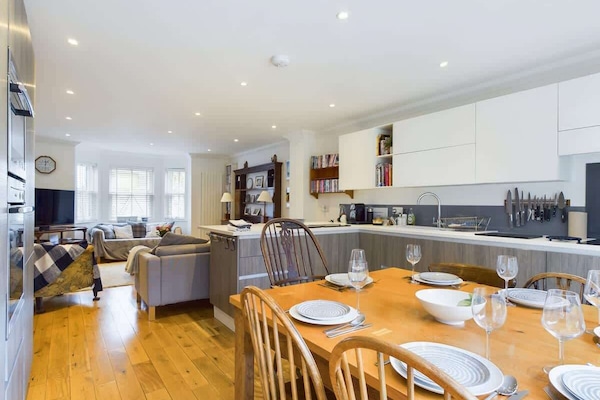 A high-spec kitchen with integrated appliances, including an induction hob and dishwasher.