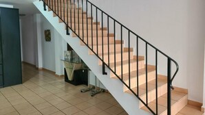 A staircase with a black railing leading to a higher floor. - Apartment ANDRES in the center of Els Poblets (Poblets (els))