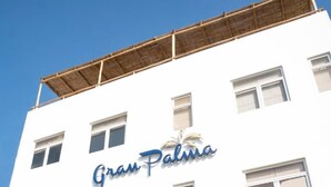 A white building with the sign "Gran Palma" on the facade.
