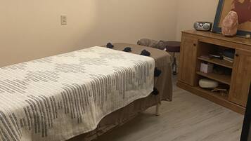 Cozy retreat with a comfortable bed, radio, and framed artwork.