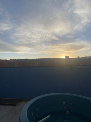 A hot tub on a rooftop with a city skyline in the background. - Charles Hotsprings (Truth or Consequences)