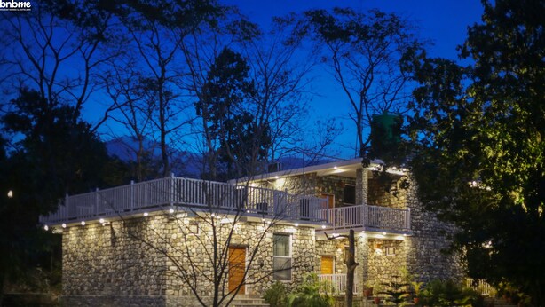 A stone building with a balcony, multiple windows, and outdoor lighting. - 1B-Wild Heritage-101 N By bnbmehomes (Salt)