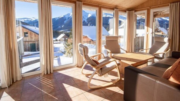 A spacious room with large windows, a wooden ceiling, and a view of snow-covered mountains. - Premium #14 mit IR-Sauna by Interhome (Hohentauern)