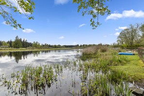 A calm lake with surrounding greenery and a clear sky. - Lakefront Gateaway at Chambers Lake - 3 bd 2 ba w/ AC (Lacey)