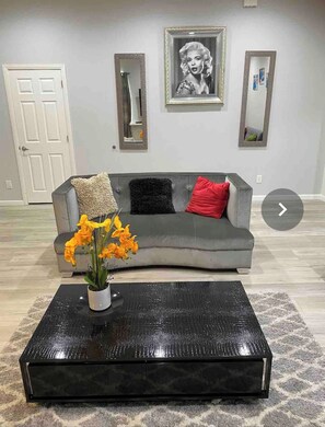 Relax in this stylish living room with a sofa, coffee table, and potted plant.
