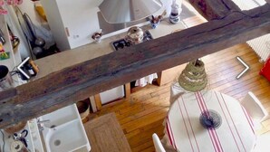 Una cocina con un lavamanos, una estufa y distintos utensilios de cocina sobre la encimera.