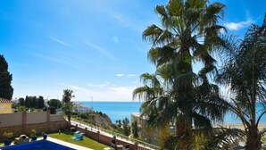 A backyard with a swimming pool, palm trees, and a view of the sea. - El balcón de la cala by Interhome (Rincón de la Victoria)