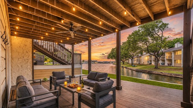 A covered outdoor seating area with a view of a river and buildings. - Lakefront Getaway ☀️ Quiet Canal - Park Your Boat 🚤 4 Bed Townhouse by EverSan Cooper Getaways (Montgomery)