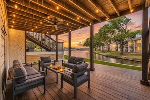 A covered outdoor seating area with a view of a river and buildings. - Boat Parking 🚤  Quiet Canal ☀️ 4 Bed Townhouse by EverSan Cooper Getaways (Montgomery)
