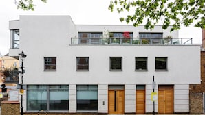 A modern building with a flat facade, large windows, and a balcony with glass railings. - Abstract Perspective, by Veeve (London)