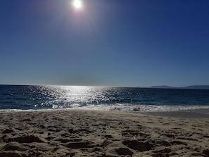 A beach with sand and water, a clear sky, and the sun shining. - Apartment 'Il Glicine' close to the Sea with Terrace & A/C (vaccileddi)