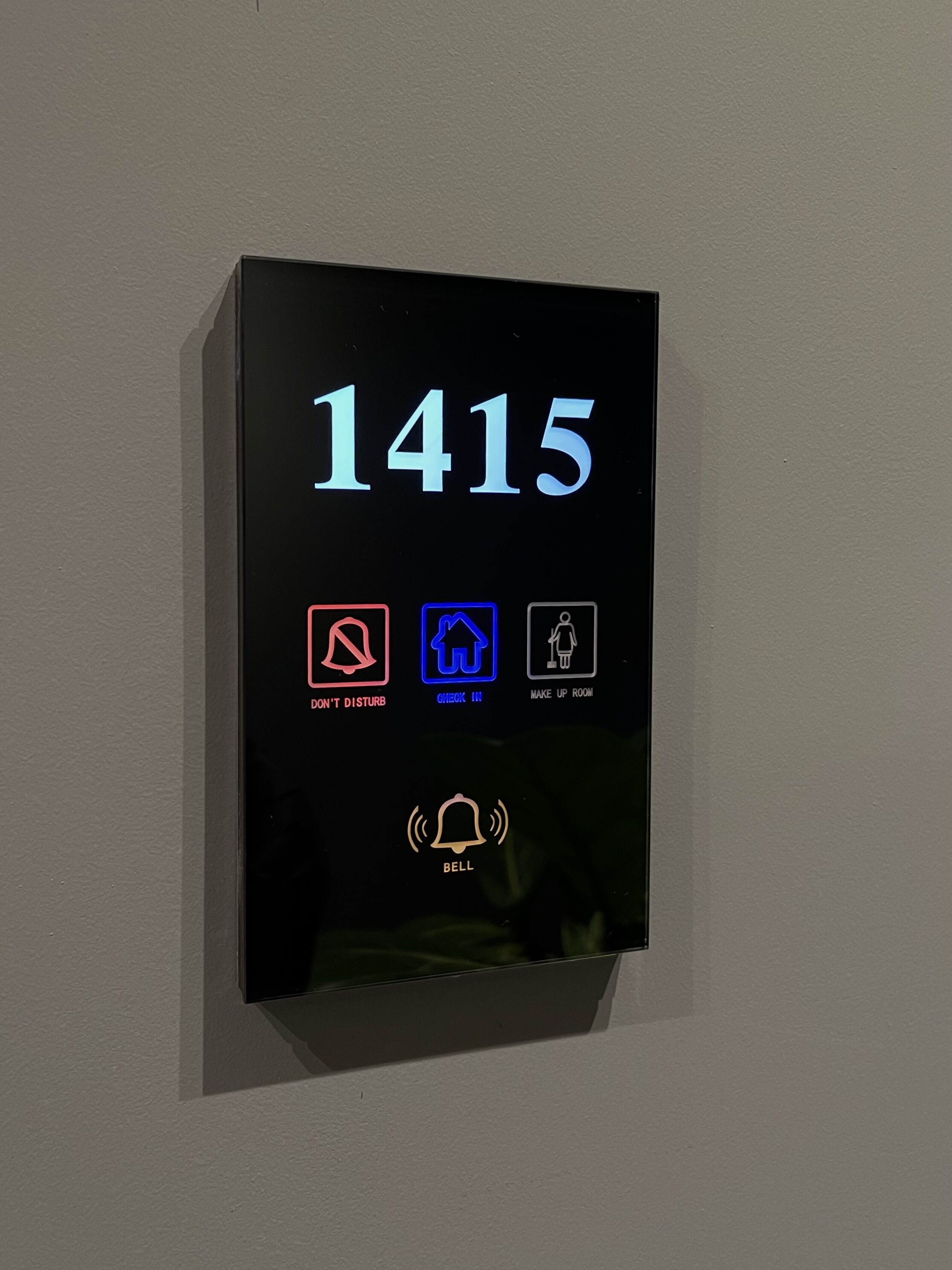 A digital display with the number 1415 and icons for 'Don't Disturb', 'Check In', 'Make Up Room', and 'Bell'.