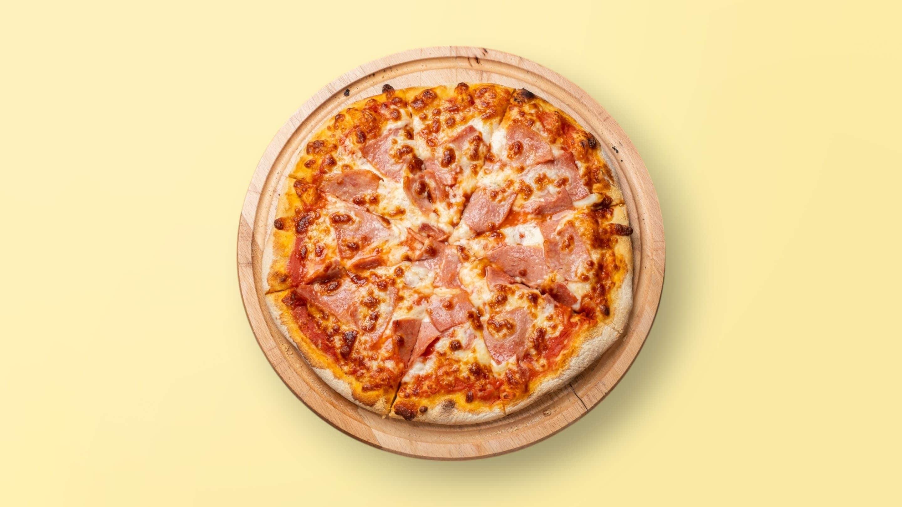 A pizza on a wooden board.