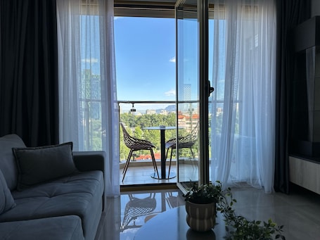 Panoramic Apartment | Living area | 50-inch Smart TV with cable channels
