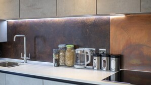 A modern kitchen with a stainless steel sink, a coffee maker, and various jars on the counter. - WS Flat 4 in Swindon (Swindon)