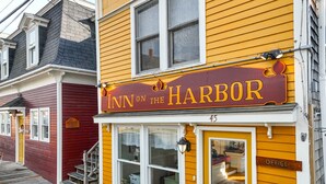 A yellow building with a sign reading "Inn on the Harbor" and an "Office" sign on the door. - The Nathaniel Bowditch - Inn on the Harbor (Stonington)
