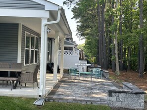 Enjoy al fresco dining and socializing in this outdoor patio area, complete with a barbecue grill and comfortable seating.