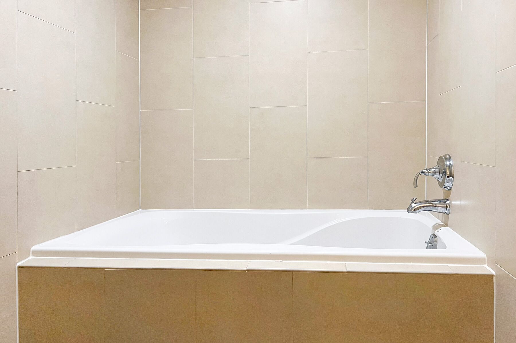 A modern bathroom with a large bathtub and a separate shower area.