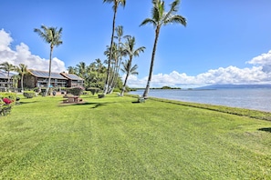 Surrounded by lush greenery and a serene body of water, this resort offers a tranquil escape with a modern building and solar panels.