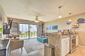 Enjoy cooking in this well-equipped kitchen with a central island, gas stove, and oven, adjacent to a dining area and patio.