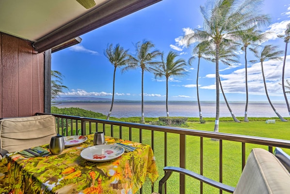 Enjoy a romantic meal on this oceanfront balcony with a table set for two.