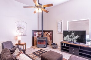 Relax by the fireplace in this inviting living room, featuring a TV and comfortable seating.