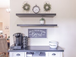 Enjoy a warm breakfast in this kitchen, equipped with a coffee maker, kettle, and coffee mug.