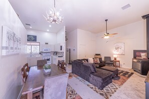 Relax in this inviting space with a comfortable sofa, dining area, and mounted TV.