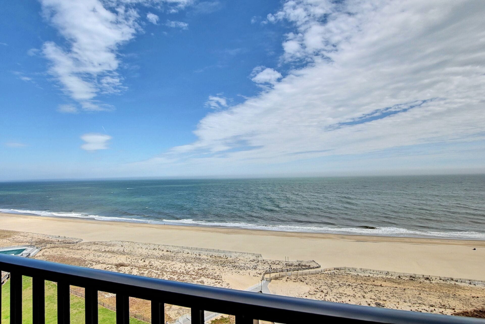 A beach with a clear view of the ocean and a sandy shoreline.