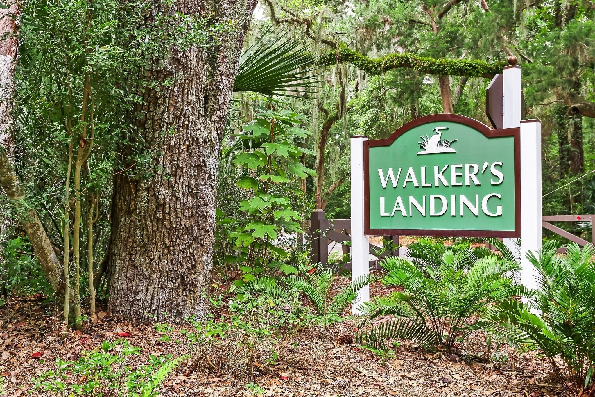 A sign reading "Walker’s Landing" in a forested area.