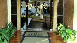 The entrance to the Lanconia Center Hotel with a glass door and a doormat. - Ancona Center Hotel (Amparo)