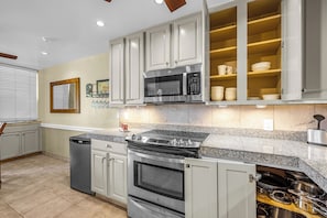 A modern kitchen with stainless steel appliances, a built-in oven, and a microwave.