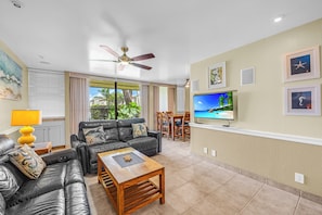 A living room with a sofa, coffee table, and TV.