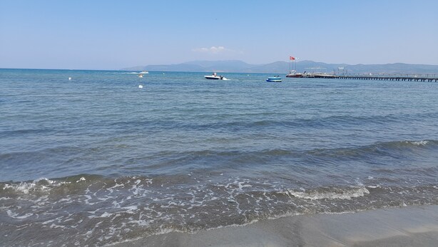 A calm sea with boats and a pier extending into the water. - Casa Callinos (Selçuk)