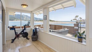 A room with a view of the beach, a bike, and a window with a plant. - Views for miles of the  Ocean and Bolinas Lagoon (Bolinas)