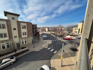 A street view with buildings, a crosswalk, and parked cars. - Studio Apartment at Cannery Square (Sun Prairie)