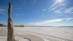 A sandy beach with a wooden post in the foreground and a clear blue sky. - White Lotus-Serene, Stylish, Relaxing-New! (Gulfport)