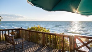 A wooden deck with a bench overlooking a body of water. - Lakefront Cottage | Private Beach + Sunset Views (Holland)