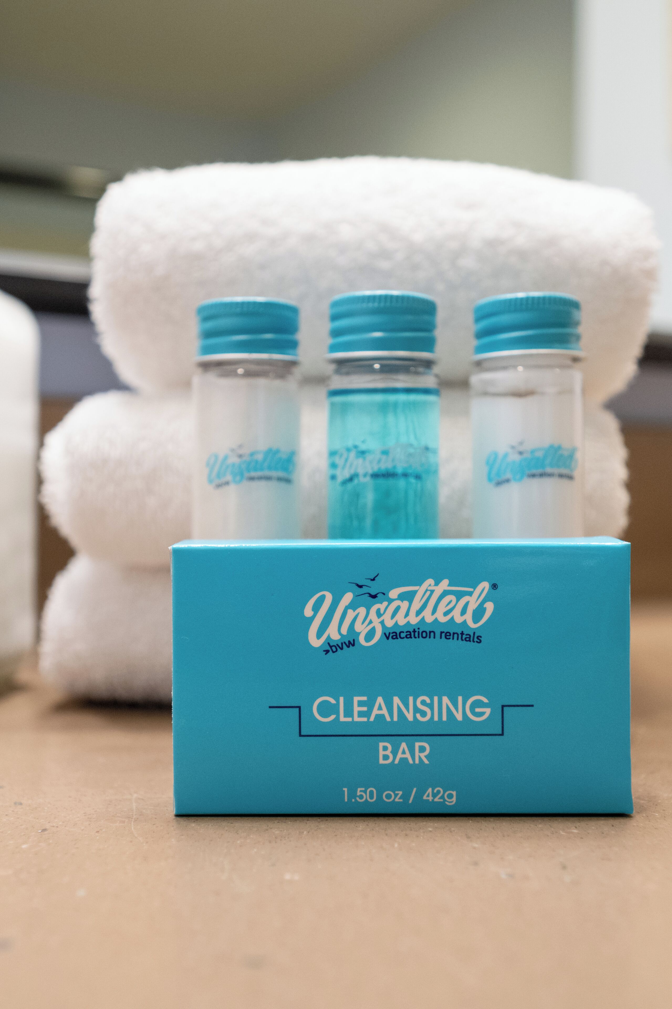 A blue box labeled "Unsalted Cleansing Bar" with three bottles of the product.