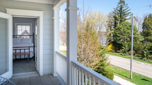 A bedroom with a bed, a window, and a view of a road and trees. - Charming Home in Douglas - Sleeps 14 (Douglas)