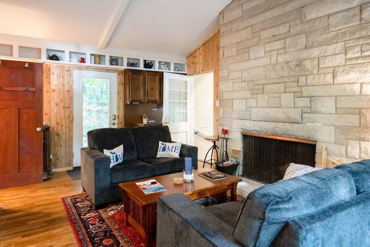 A cozy living room with a fireplace, a sofa, and a coffee table.