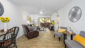 A modern living room with a sofa, armchairs, a coffee table, and a dining area. - CASA AMARILLO - Anasazi Village - Updated Top Floor Unit (Phoenix)