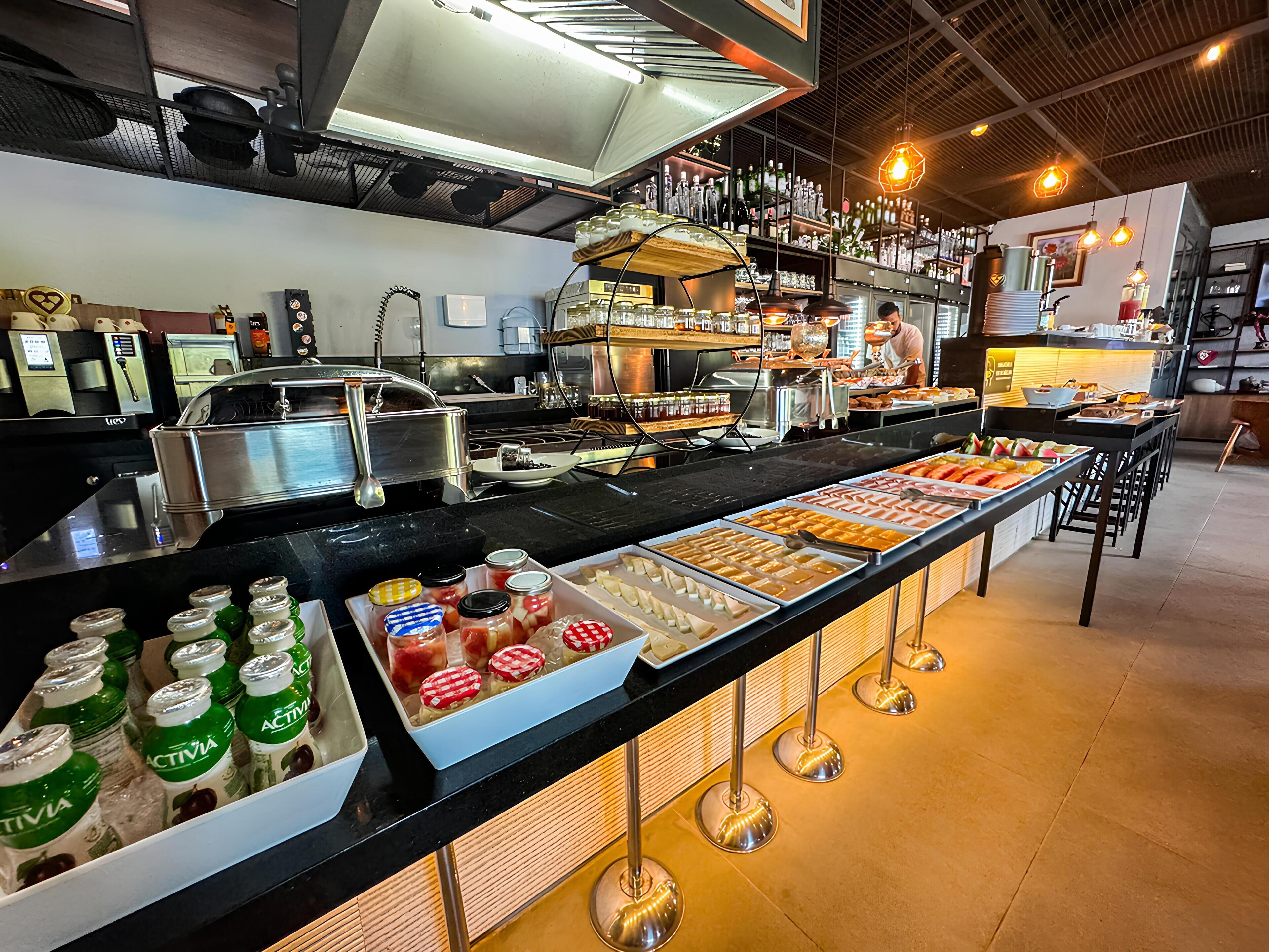 A buffet area with various food options and a beverage station.