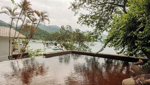 A swimming pool with a view of a lake and mountains. -  Pousada Papiro Boutique (Angra dos Reis)