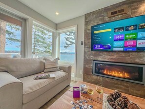 TV connectée, cheminée, livres, chaîne hi-fi