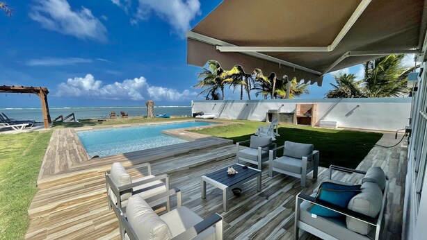 A poolside area with outdoor seating, a barbecue, and a view of the ocean. - NEW LISTING! OCEAN FRONT AND RAINFOREST 16 GUESTS (Río Grande)