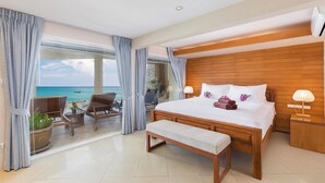 A hotel room with a large bed, a bench, a wooden headboard, a nightstand, and a view of the ocean. - Your exclusive villa on the sand, Private Pool, Stunning Ocean Views (Tambon Patong, Amphoe Kathu)